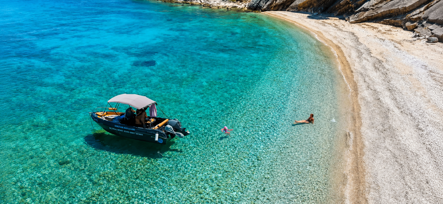 Small motorboat on crystal clear turquoise water near Skala, Kefalonia