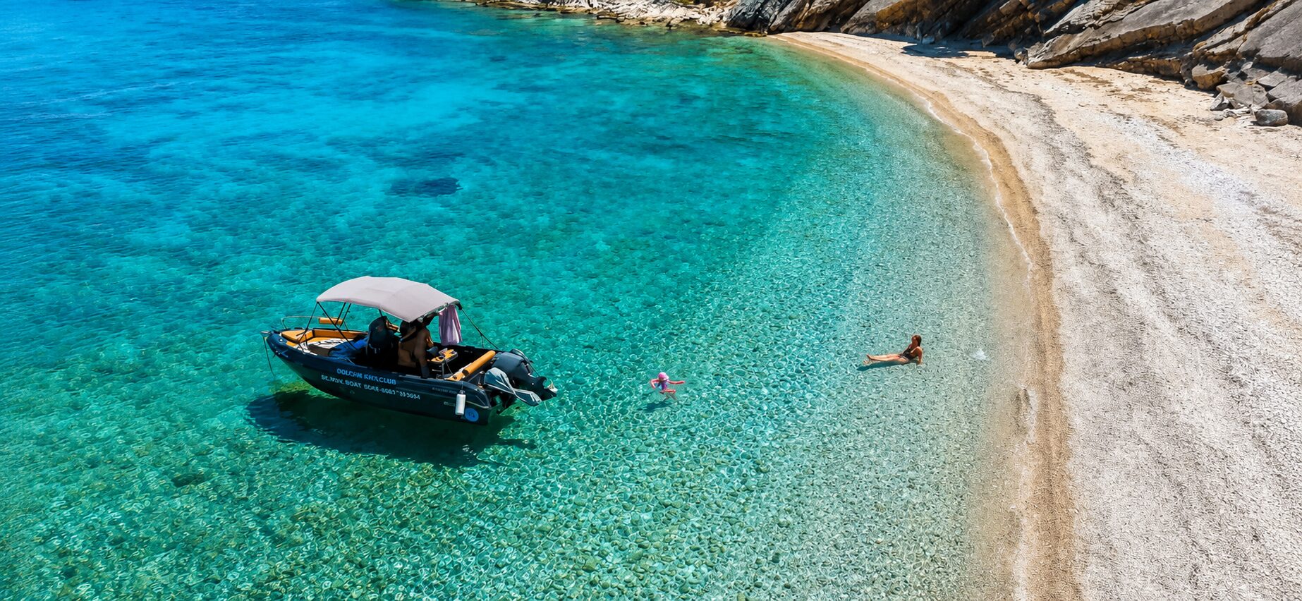 Small motorboat on crystal clear turquoise water near Skala, Kefalonia