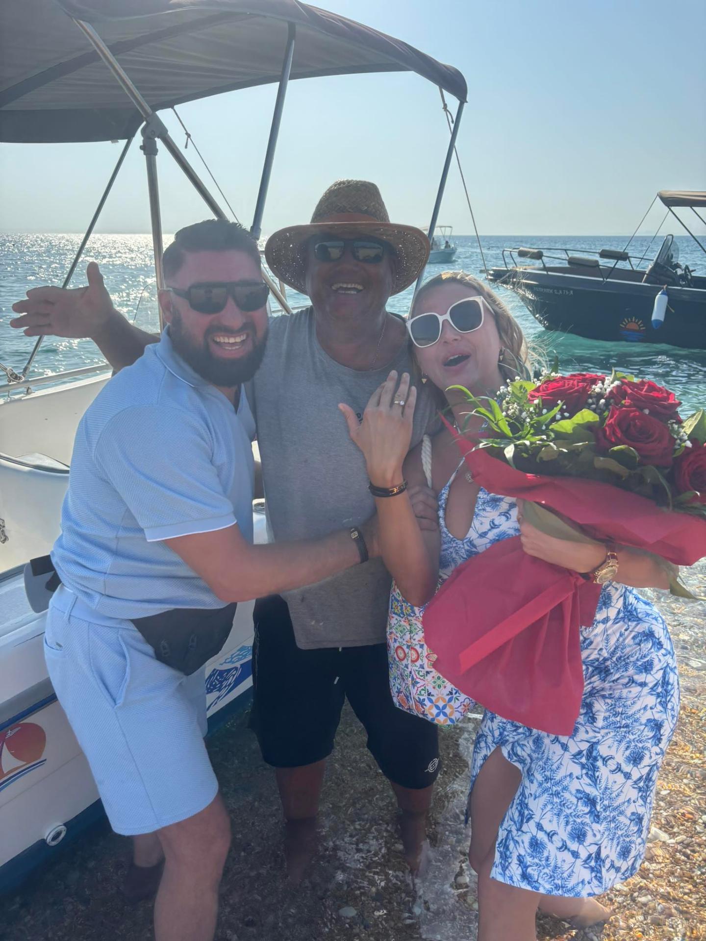 Guests smiling on Skala beach with a Dolphin Ski Club captain