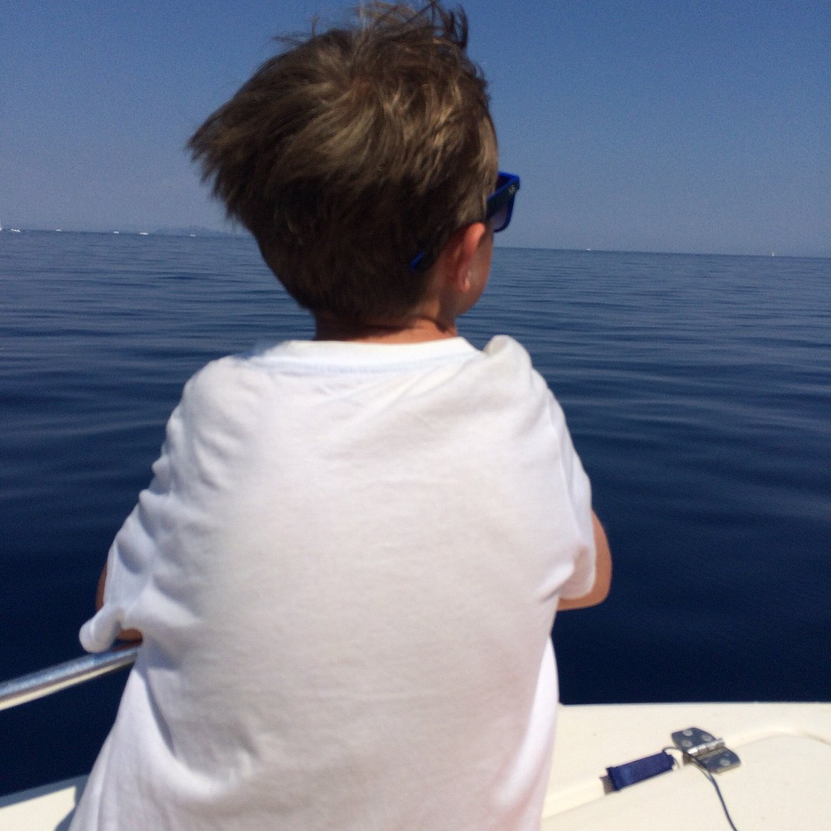 A young guest looking out over calm Ionian sea