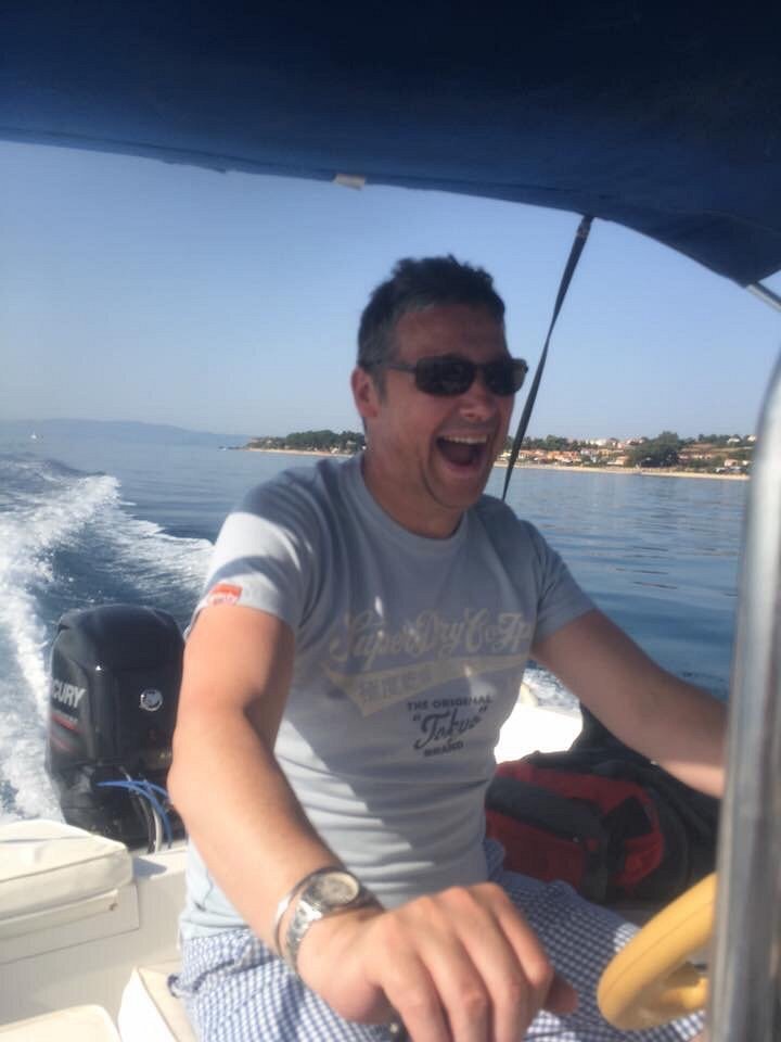 A guest driving a Dolphin Ski Club motorboat