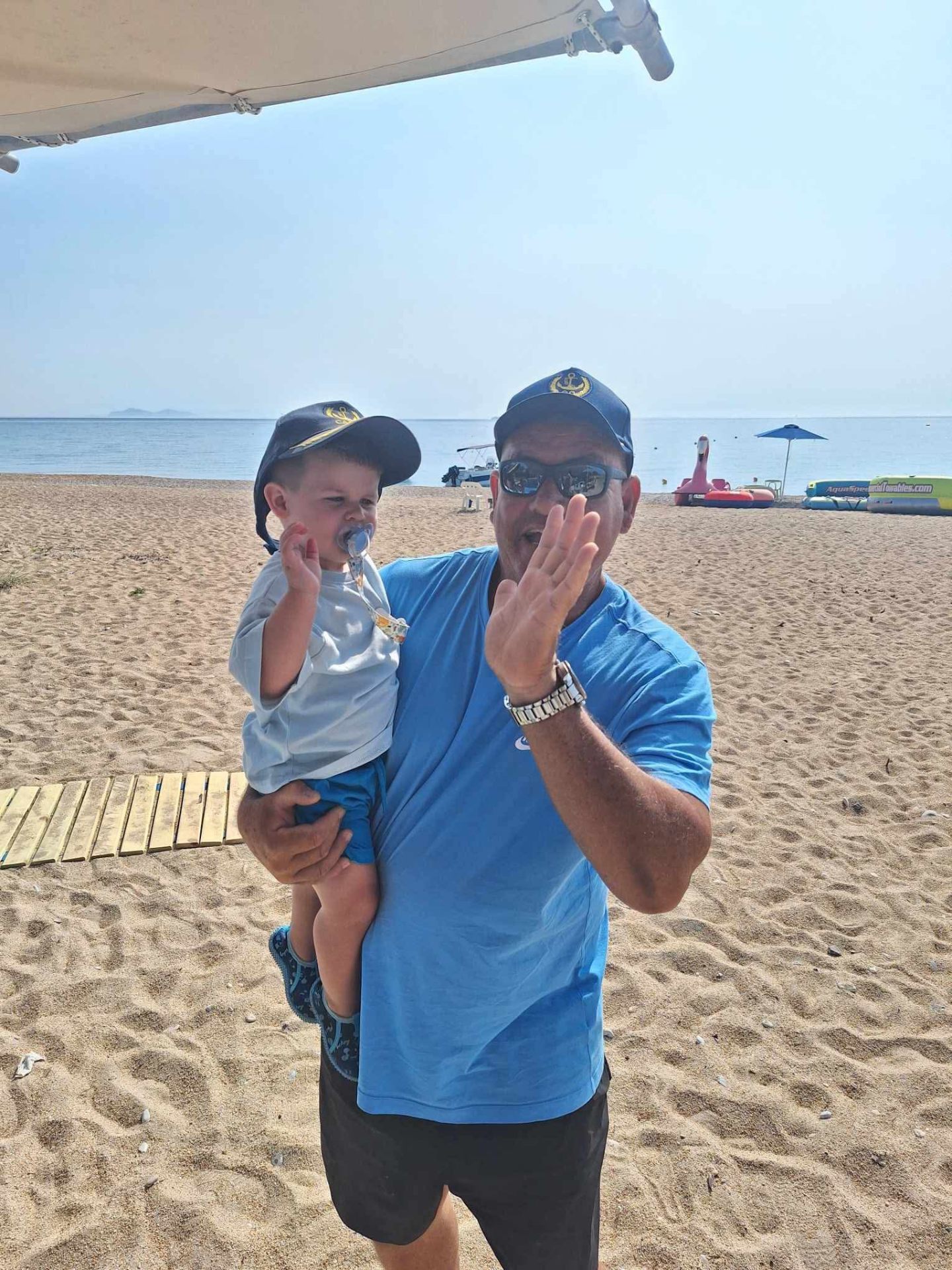 A Dolphin Ski Club team member with a young guest on the beach
